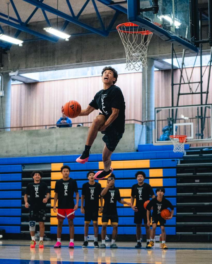 Athlete elevating for a dunk at a National NIL Sports camp